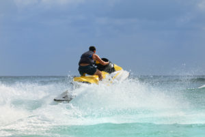 Man on Wave Runner turns fast on the water